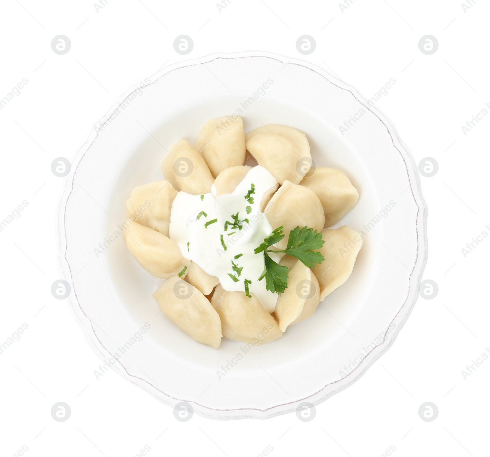 Photo of Delicious cooked dumplings with sour cream on white background, top view