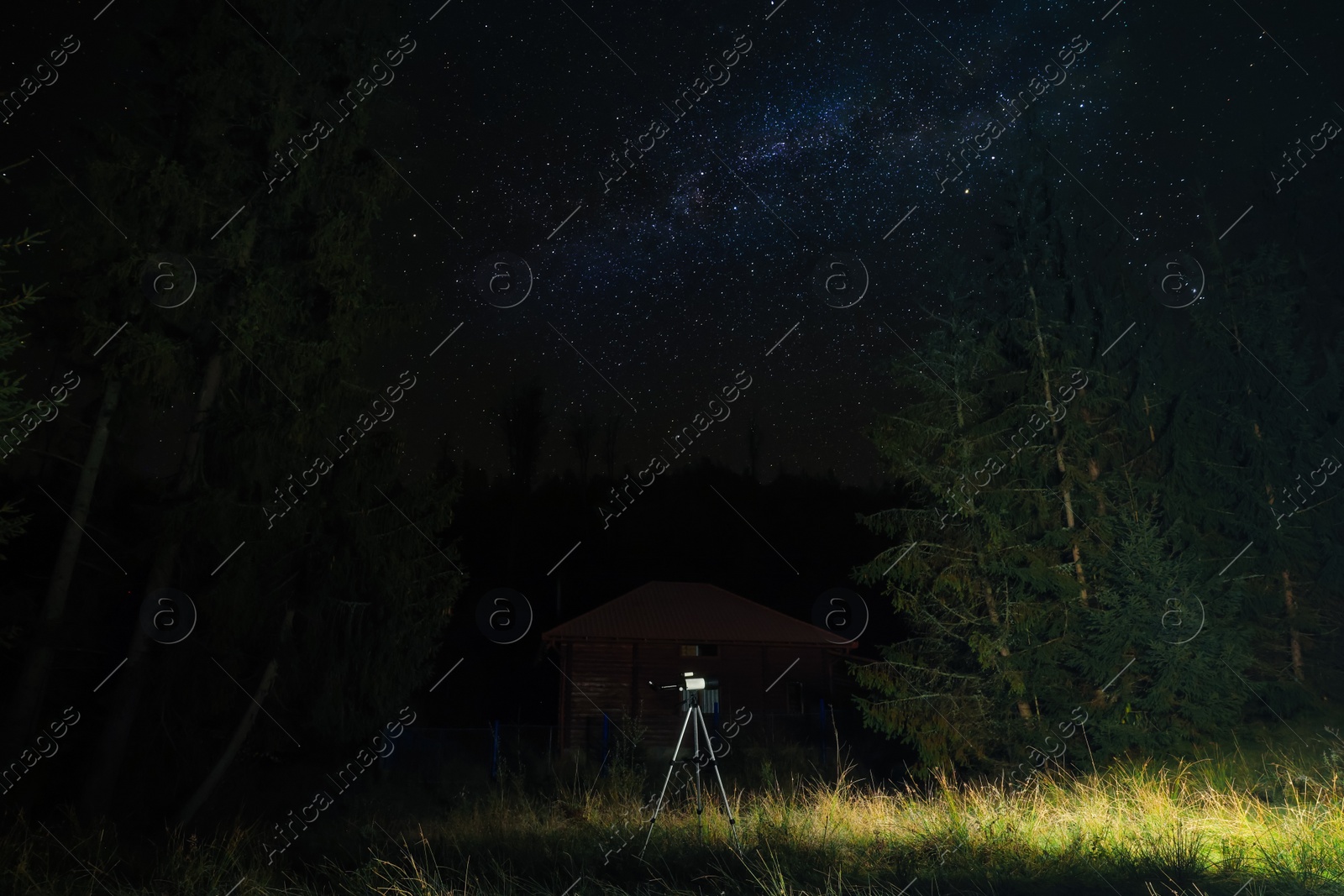 Photo of Modern telescope at night outdoors. Learning astronomy