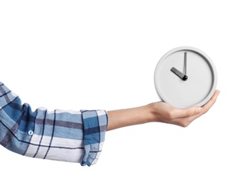 Young woman holding clock on white background. Time management