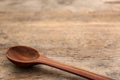 Clean spoon and space for text on wooden background