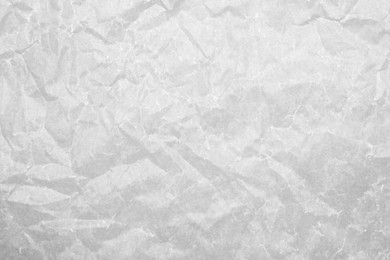 Photo of Texture of crumpled white baking paper as background, top view