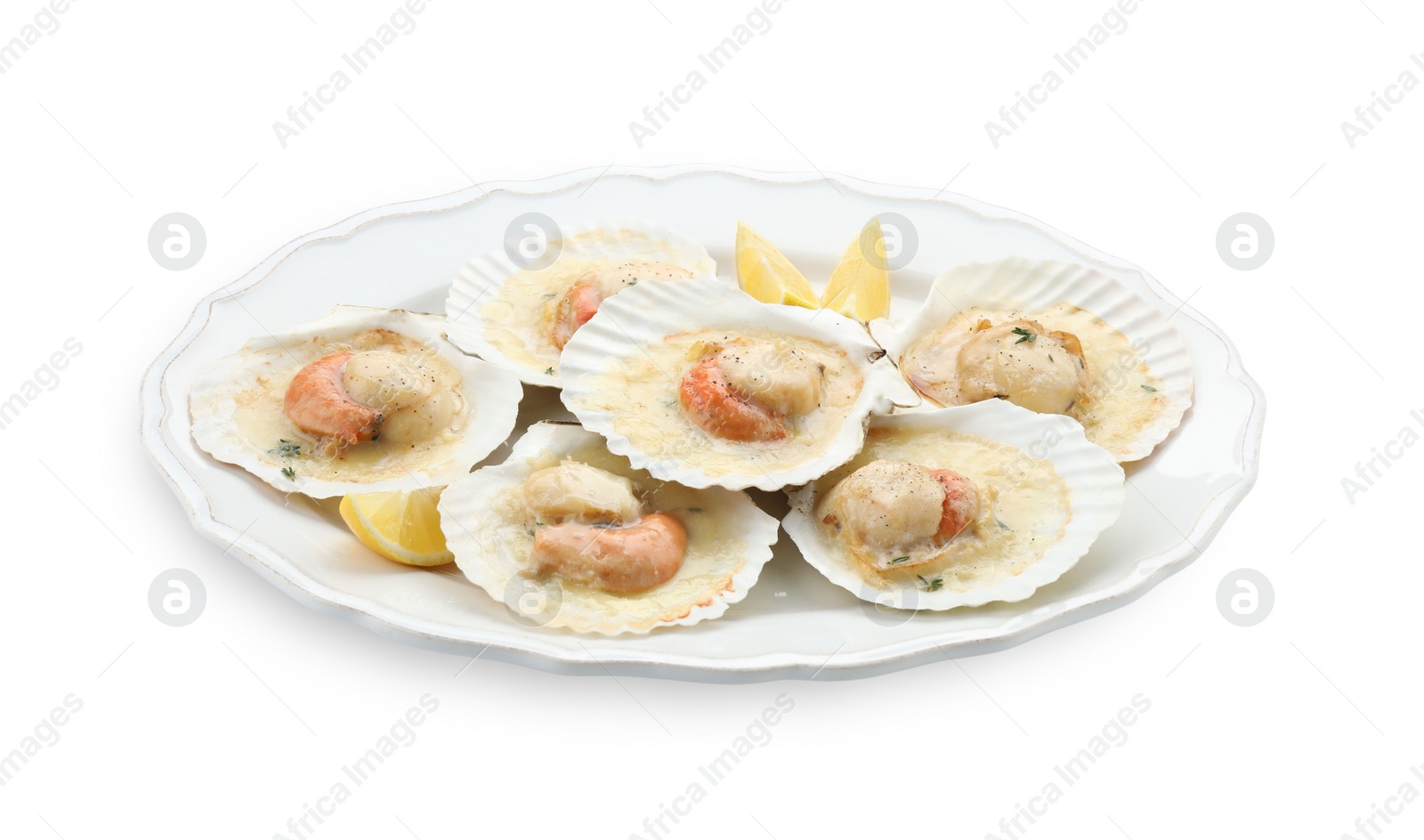 Photo of Fried scallops in shells and lemon isolated on white