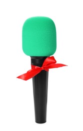 Photo of Microphone with red bow isolated on white. Christmas music