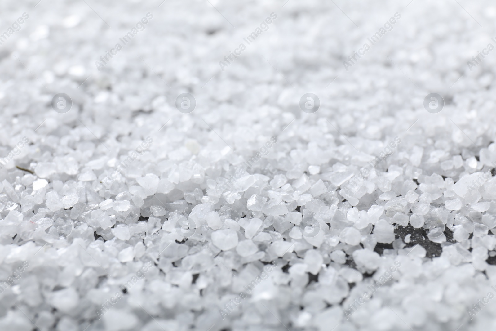 Photo of White natural salt as background, closeup view