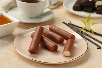 Photo of Glazed vanilla curd cheese bars served on beige table