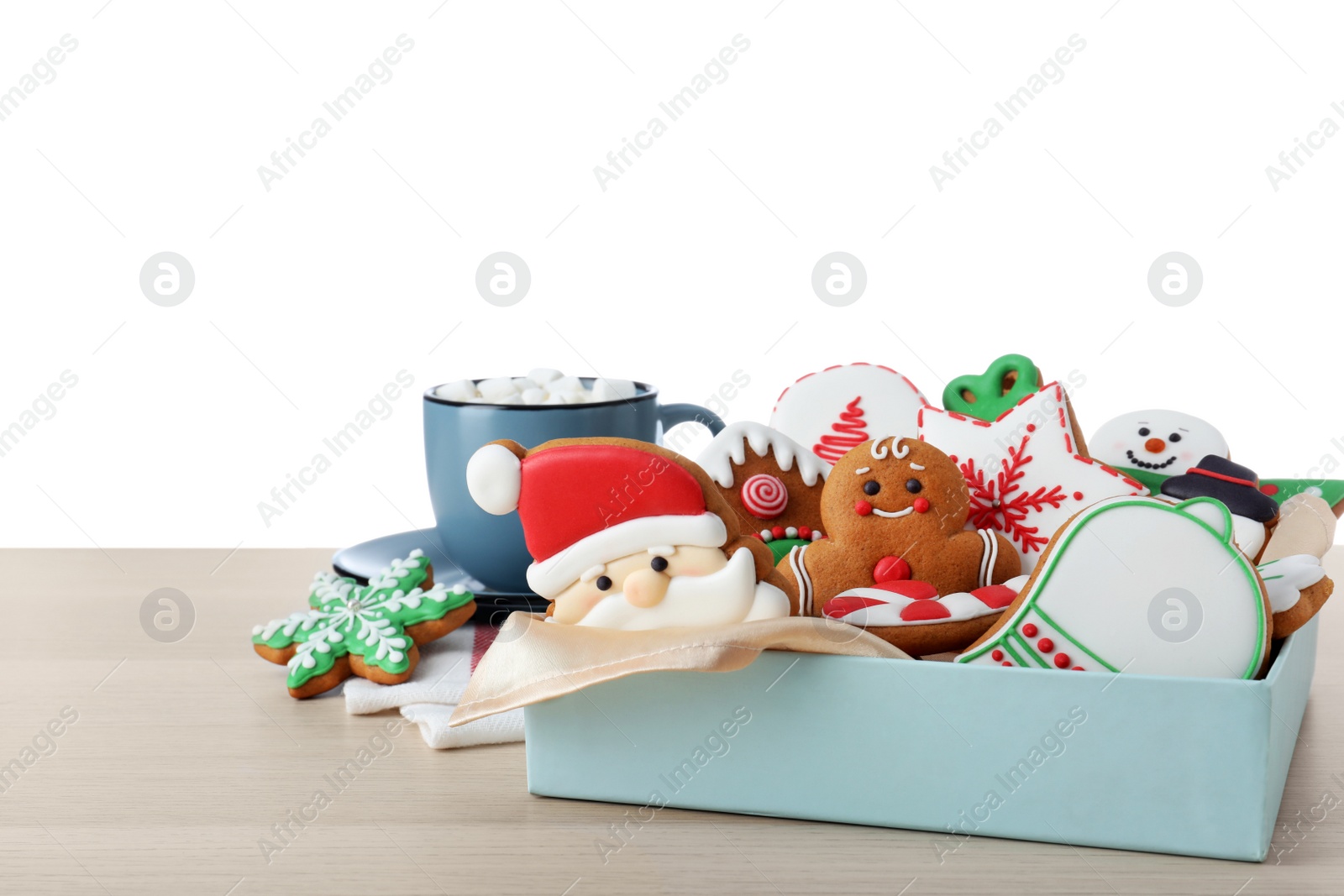 Photo of Tasty Christmas cookies and cup of delicious drink on wooden table against white background