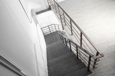 Photo of Stone stairs with metal railing indoors, view through CCTV camera