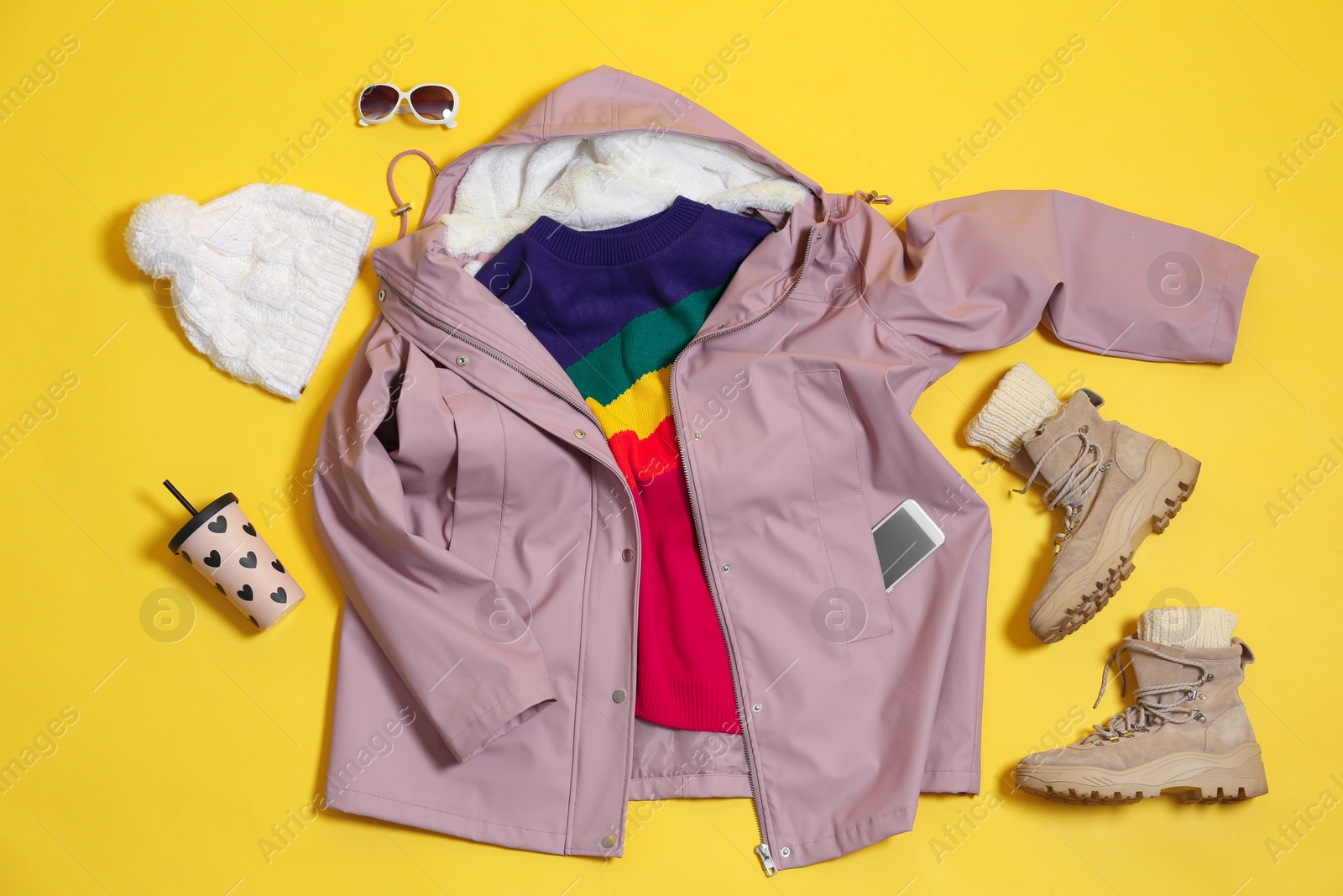 Photo of Set of warm clothes on color background, flat lay. Winter vacation