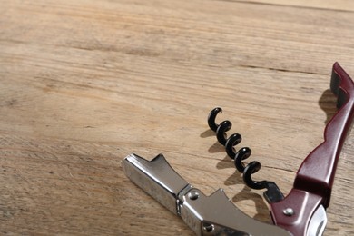 One corkscrew (sommelier knife) on wooden table. Space for text