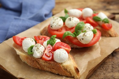 Delicious sandwiches with mozzarella, fresh tomatoes and basil on parchment
