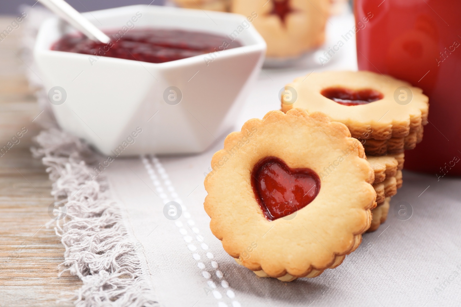 Photo of Traditional Christmas Linzer cookies with sweet jam on table