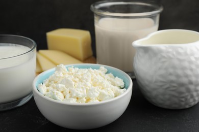 Photo of Lactose free dairy products on black textured table, closeup