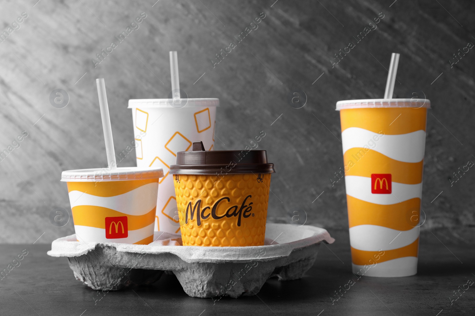 Photo of MYKOLAIV, UKRAINE - AUGUST 12, 2021: Cold and hot McDonald's drinks on grey table