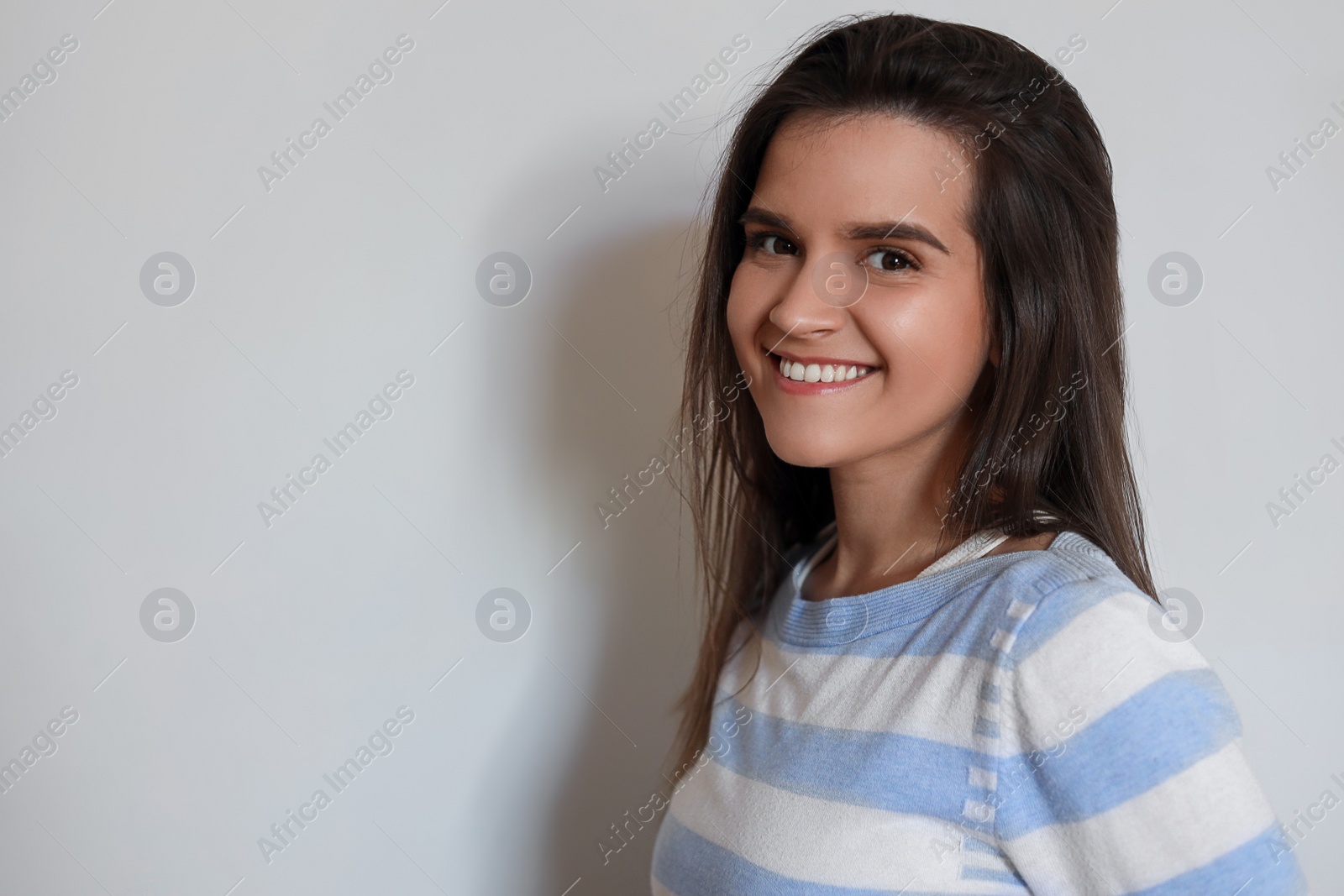 Photo of Portrait of beautiful young woman on white background, space for text