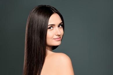 Photo of Portrait of beautiful model with gorgeous straight hair on color background