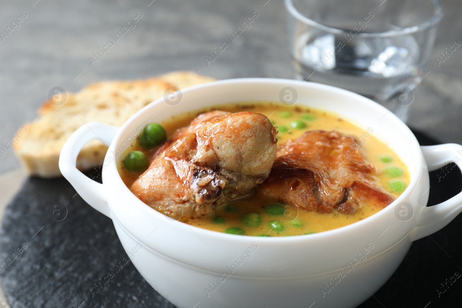 Photo of Tasty cooked rabbit meat with sauce served on table, closeup