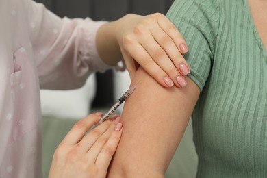 Diabetes. Woman getting insulin injection indoors, closeup