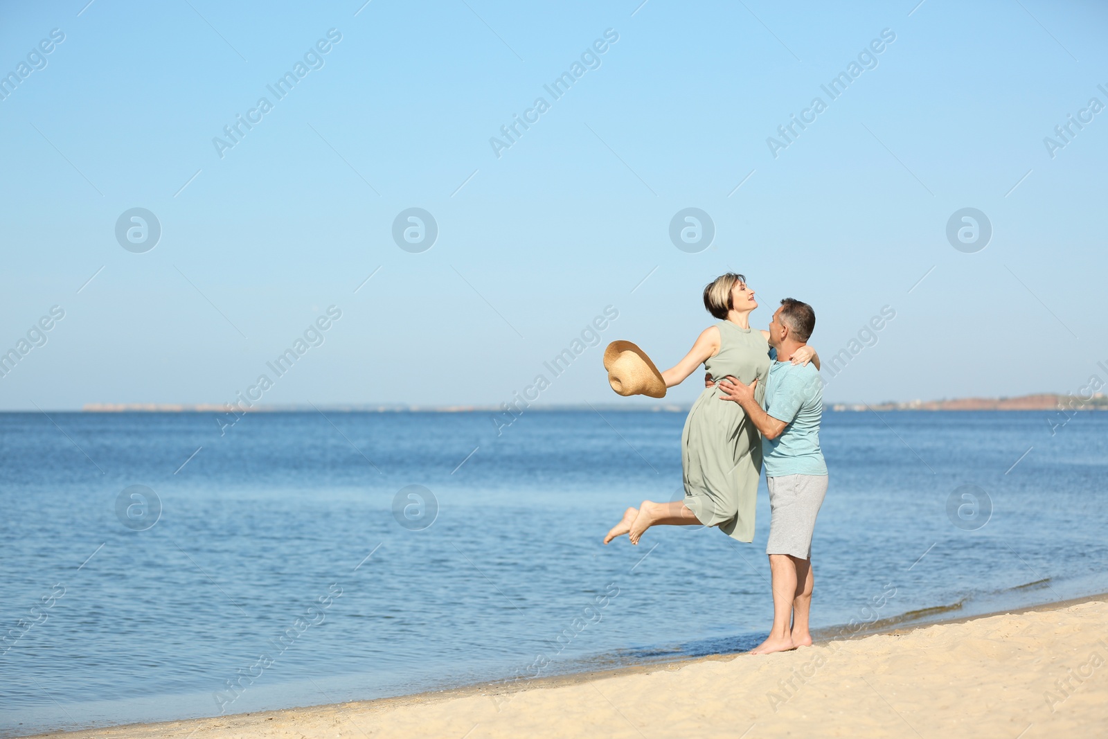 Photo of Happy mature couple at beach on sunny day