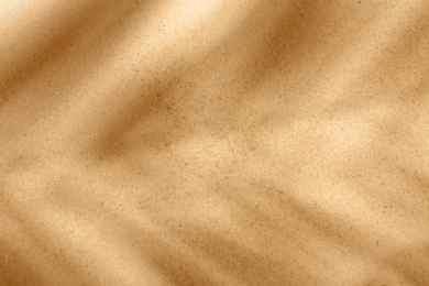 Photo of Dry beach sand as background, top view