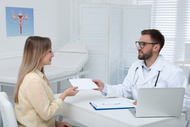Photo of Young woman having appointment with gynecologist in clinic