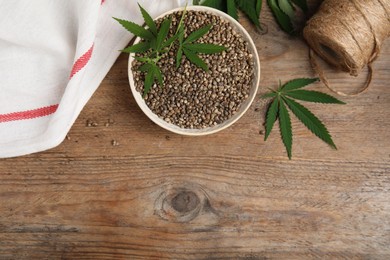 Photo of Flat lay composition with hemp seeds on wooden table. Space for text