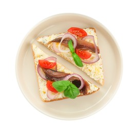 Photo of Delicious sandwiches with anchovy, tomato and basil on white background, top view