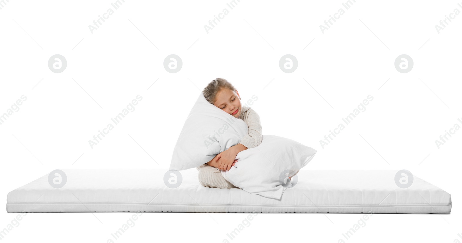 Photo of Sleepy girl hugging pillow on mattress against white background