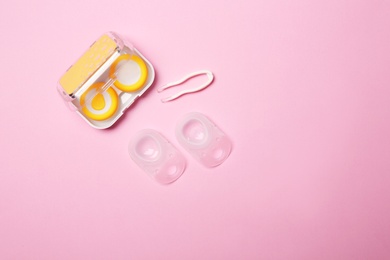 Flat lay composition with contact lenses and accessories on color background