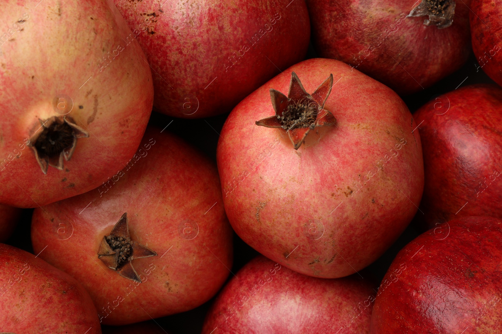 Photo of Fresh ripe pomegranates as background, top view