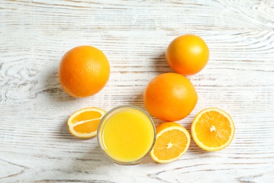 Photo of Glass of orange juice and fresh fruits on table