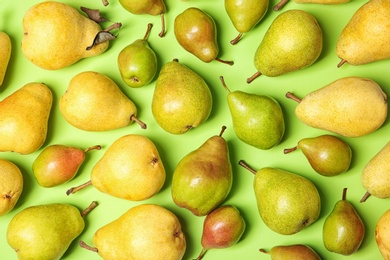 Flat lay composition with fresh ripe pears on color background