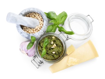 Photo of Fresh tasty pesto sauce and ingredients isolated on white, top view