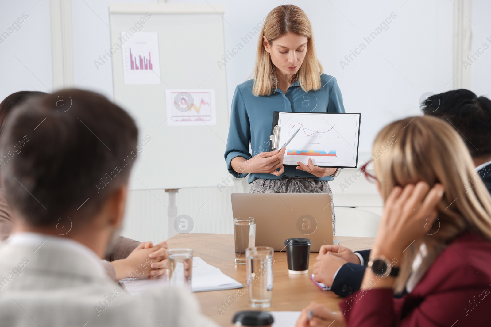 Photo of Businesswoman showing chart on meeting in office