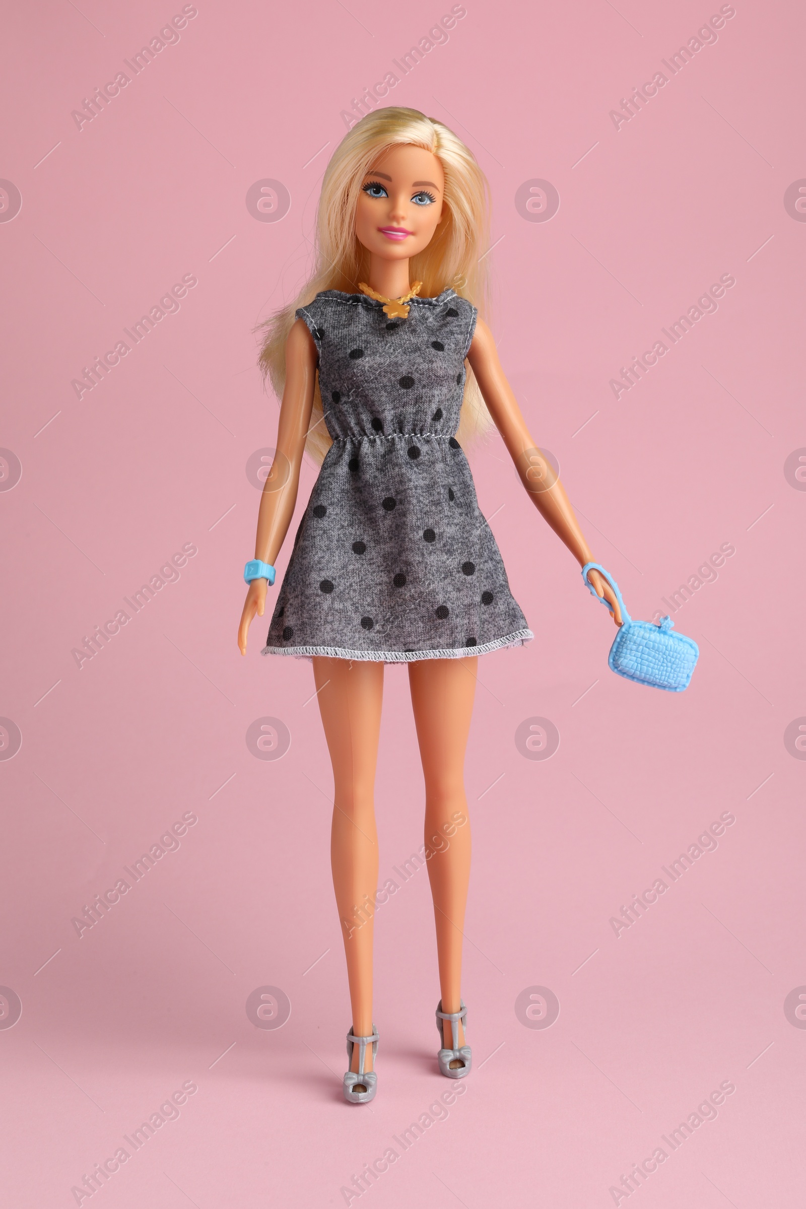 Photo of Mykolaiv, Ukraine - September 2, 2023: Beautiful Barbie doll with bag on pale pink background