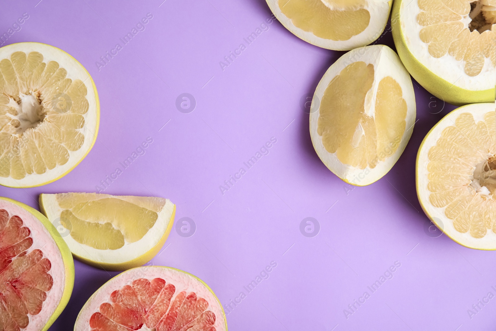 Photo of Fresh cut pomelo fruits on lilac background, flat lay. Space for text