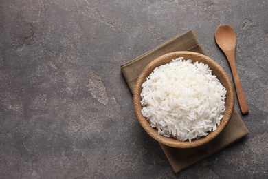 Photo of Bowl of delicious cooked rice served on table, flat lay. Space for text