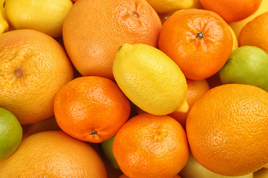 Tangerines, oranges, limes and lemon as background, top view