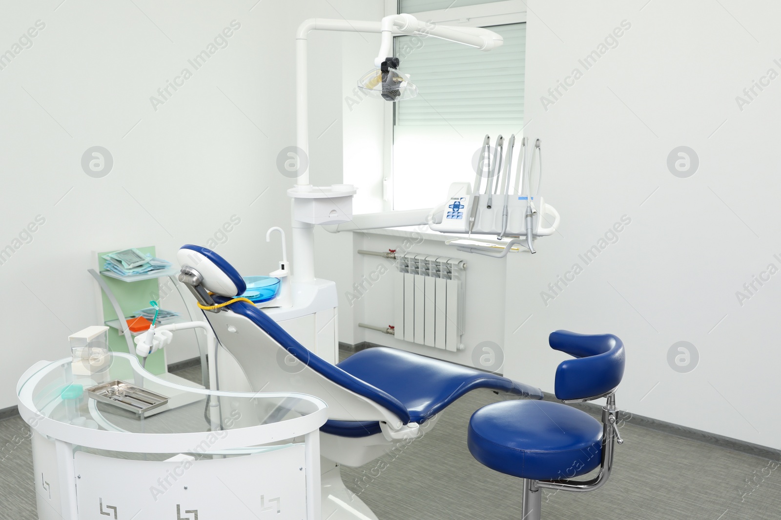 Photo of Dentist's office interior with chair and equipment