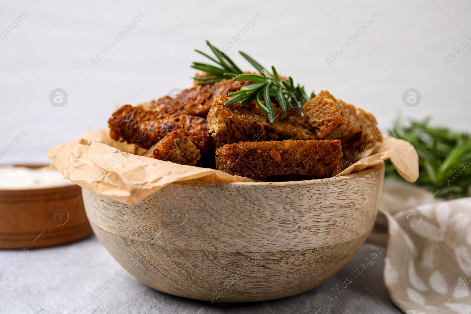 Photo of Crispy rusks with rosemary on white table