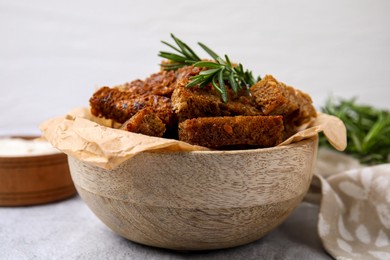 Crispy rusks with rosemary on white table