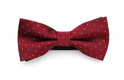 Photo of Stylish burgundy bow tie with polka dot pattern on white background, top view