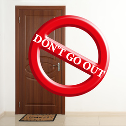 Image of Closed door and sign DON'T GO OUT. Stay at home during coronavirus quarantine
