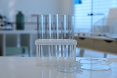 Photo of Laboratory analysis. test tubes and petri dishes on white table indoors