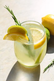 Tasty refreshing lemonade and ingredients on light table. Summer drink