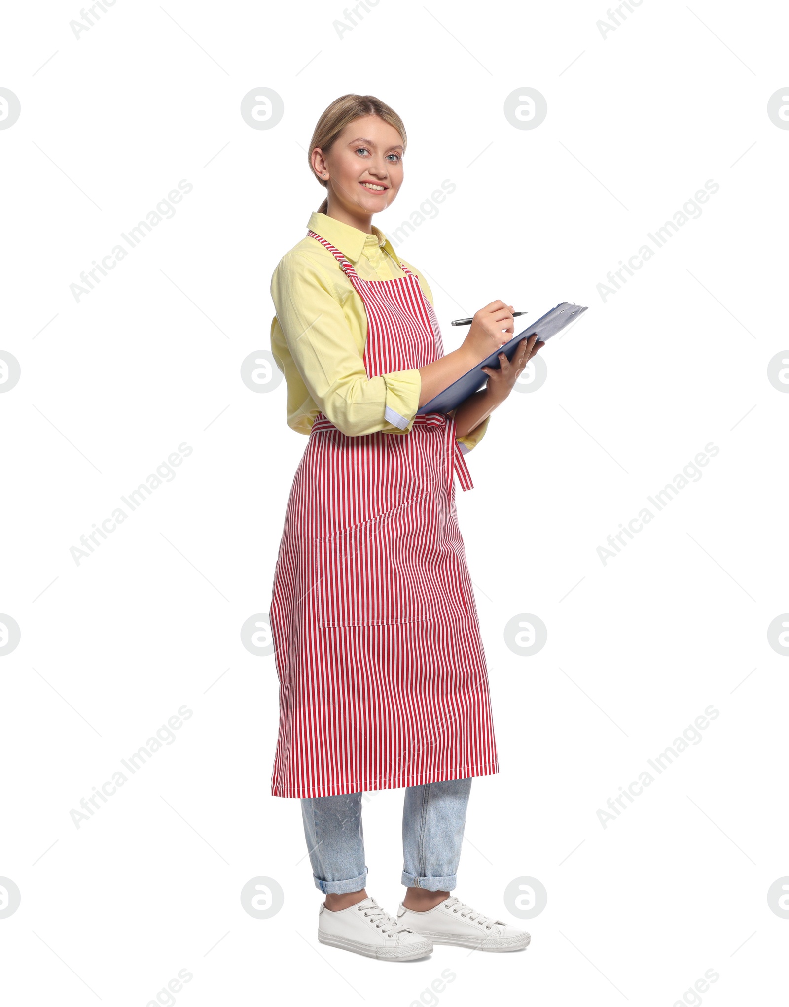 Photo of Beautiful young woman in clean striped apron with clipboard on white background