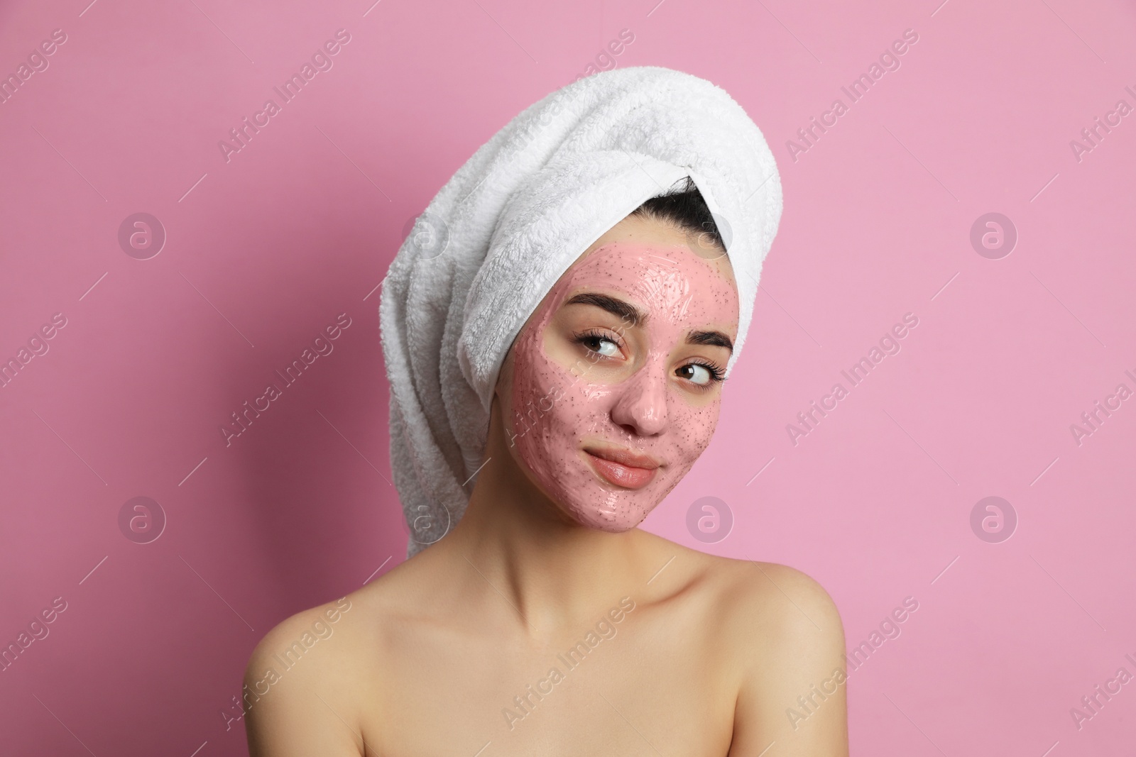 Photo of Woman with pomegranate face mask on pink background