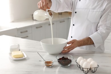 Professional chef making dough at white marble table indoors, closeup