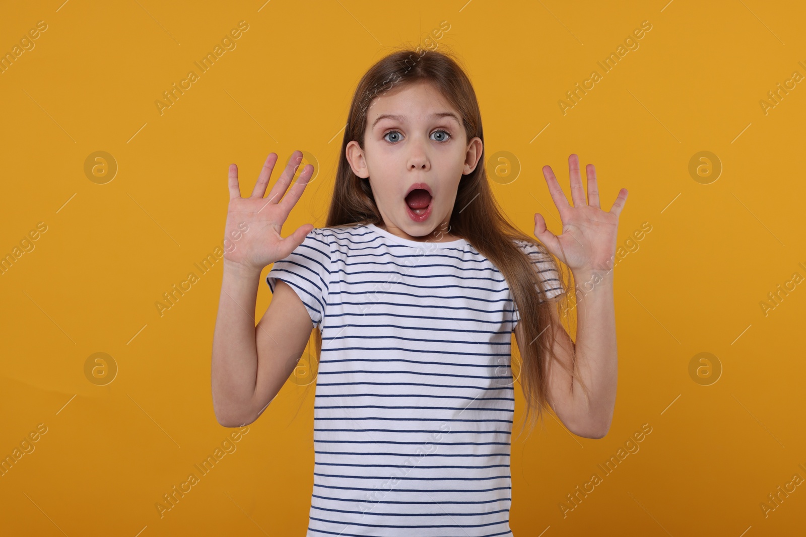 Photo of Portrait of surprised girl on yellow background