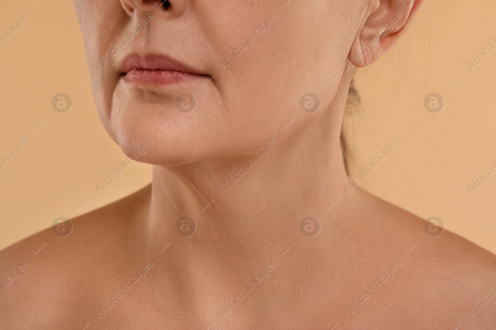 Photo of Woman with normal skin on beige background, macro view
