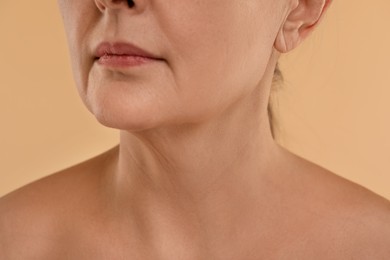 Woman with normal skin on beige background, macro view